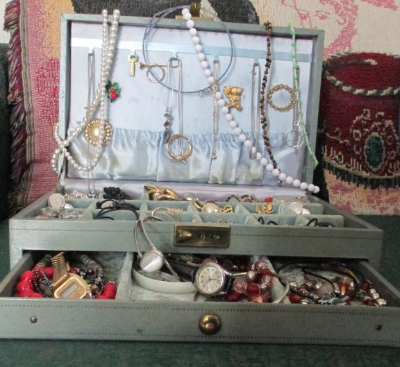 Vintage jewelry box full of vintage costume jewelry.