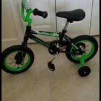 Childs bicycle with training wheels for sale in Fort Pierce FL by Garage Sale Showcase member drobbins, posted 12/10/2021