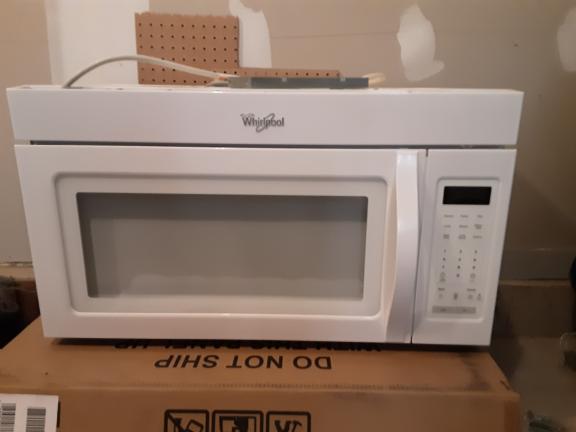Microwave Whirlpool  has 2 speed fan/light/clock. mounts above stove. for sale in Mchenry IL